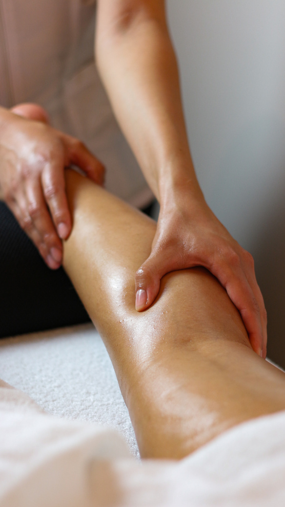 Hands Massaging a Person's Leg